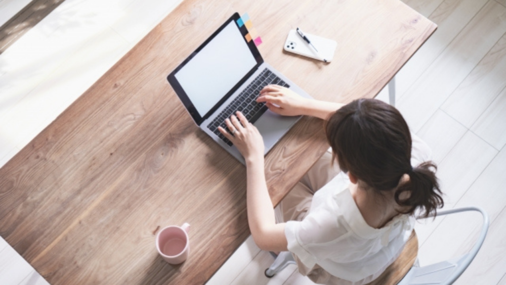 PCを開く女性の上からの図
